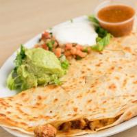 Chicken Quesadilla · Grilled Chicken Quesadilla is served in a large flour tortilla with Monterey Jack and Chedda...