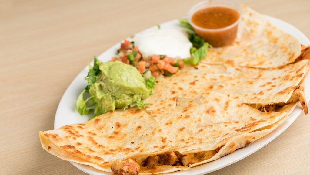 Chicken Quesadilla · Grilled Chicken Quesadilla is served in a large flour tortilla with Monterey Jack and Cheddar Cheese. . The quesadilla is garnished with Guacamole, Sour Cream and Pico de Gallo.