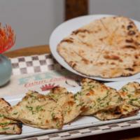 Naan · Flatbread cooked to perfection in a traditional tandoor oven, finished with a brush of butter