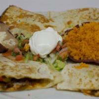 Fajitadilla · Soft flour tortilla stuffed with sliced chicken or steak sauteed with bell peppers and onion...