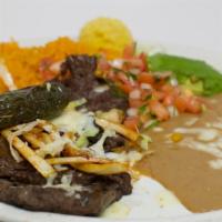 Carne Asada · Skirt steak broiled in a special way. Served with sautéed mushrooms, onions and melted Monte...