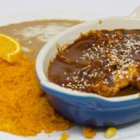 Chicken Mole · SLICES OF Chicken. breast an a delicious sweet Mexican sauce topped with sesame seeds