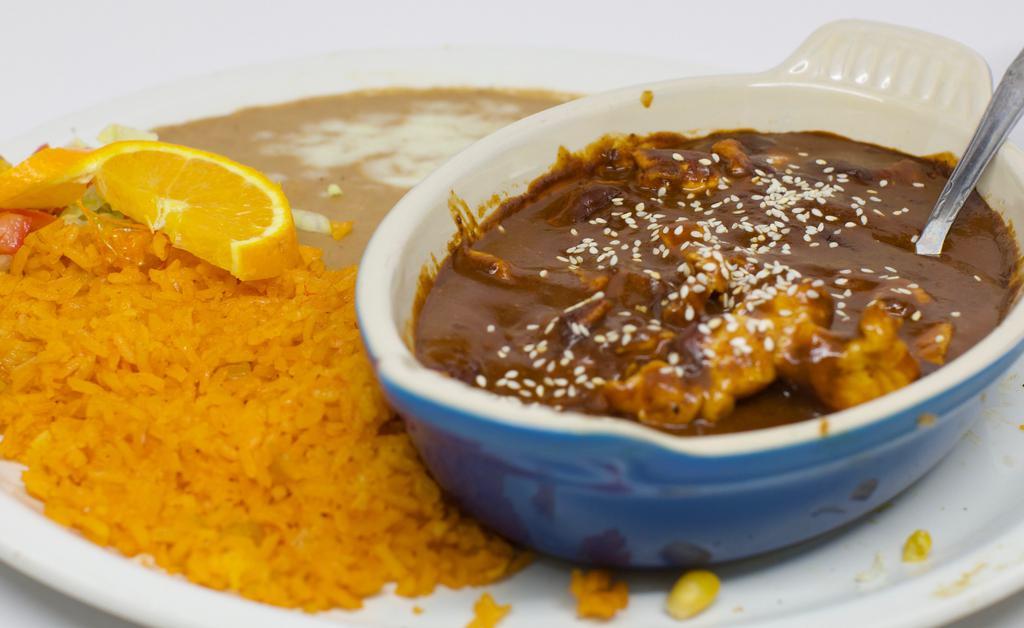 Pollo En Mole Poblano · Slices Of Chicken Breast In a Delicious Sweet Mexican poblano mole with Sesame Seeds.