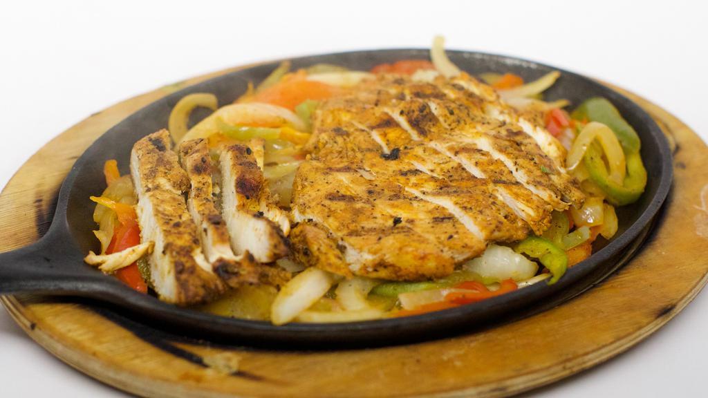 Chicken, Beef Or Mixed Fajitas · Your choice of tender sliced chicken, beef or a combination of both. Cooked with onions, tomatoes and bell peppers, guacamole salad and sour cream. Served with rice, three flour tortillas and refried beans with cheese.
