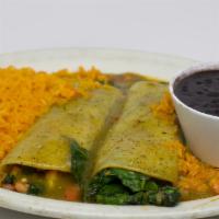 Enchilada De Espinaca · Two corn tortillas filled with spinach, onions, tomatoes, and mushrooms. Smothered in salsa ...