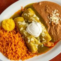 Enchilada Suiza · Two corn tortillas stuffed with your choice of meat. Topped with a delicious green tomatillo...