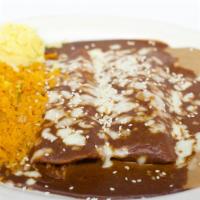 Enchilada De Mole · Two corn tortillas stuffed with tender chicken and topped with our delicious sweet, spicy Me...