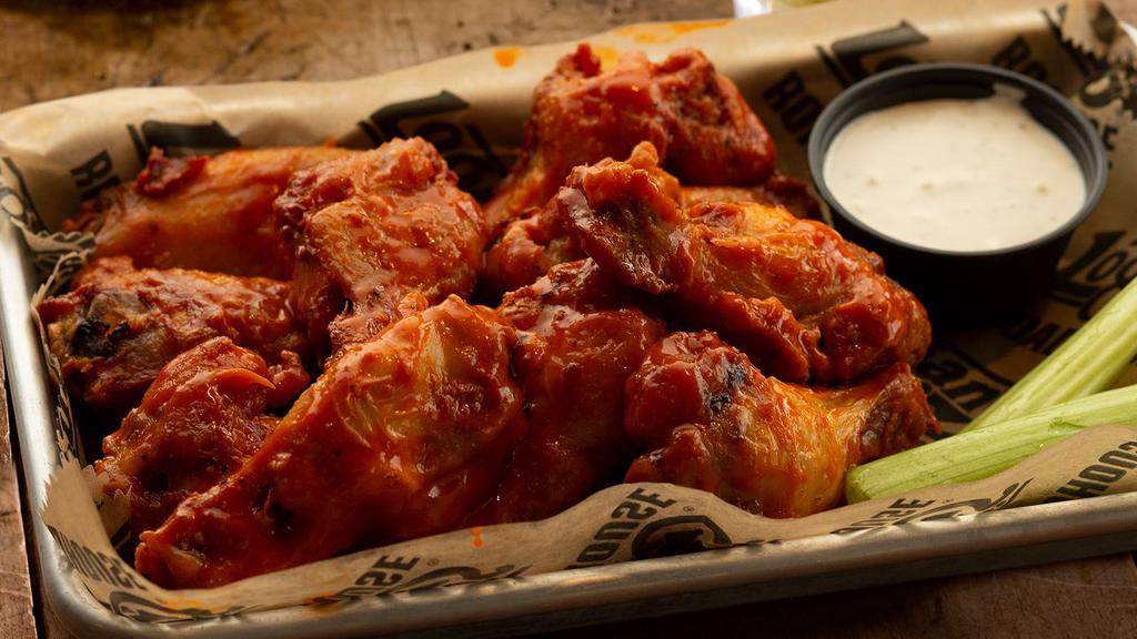 Roadhouse Wings · Our signature wings fried to perfection in your choice of garlic parmesan, buffalo, cajun dry rub or moonshine glaze, served with celery sticks and blue cheese dressing.