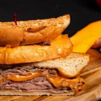 Les Baux Tri-Tip Sandwich · Roasted tri-tip with caramelized onion and brie on a baguette.