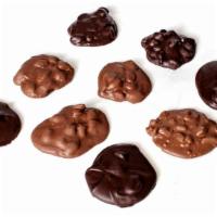Sf Pecan Cluster · Crunchy roasted pecans covered un sugar free milk or dark chocolate
