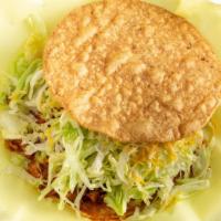 Carne Asada Tostadas · Topped with beans, lettuce, and cheese.