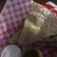 Quesadillas (Sides) · A flour tortilla with cheese and side of sour cream.