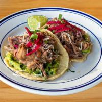 Carnitas Taco · 2 tacos per order, served on our made-to-order corn tortillas, guacamole, cheese, pickled re...