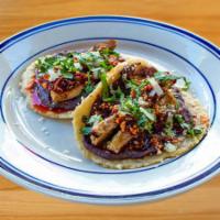 Chicken Taco · 2 tacos per order, served on our made-to-order corn tortillas, black bean purée, onions and ...