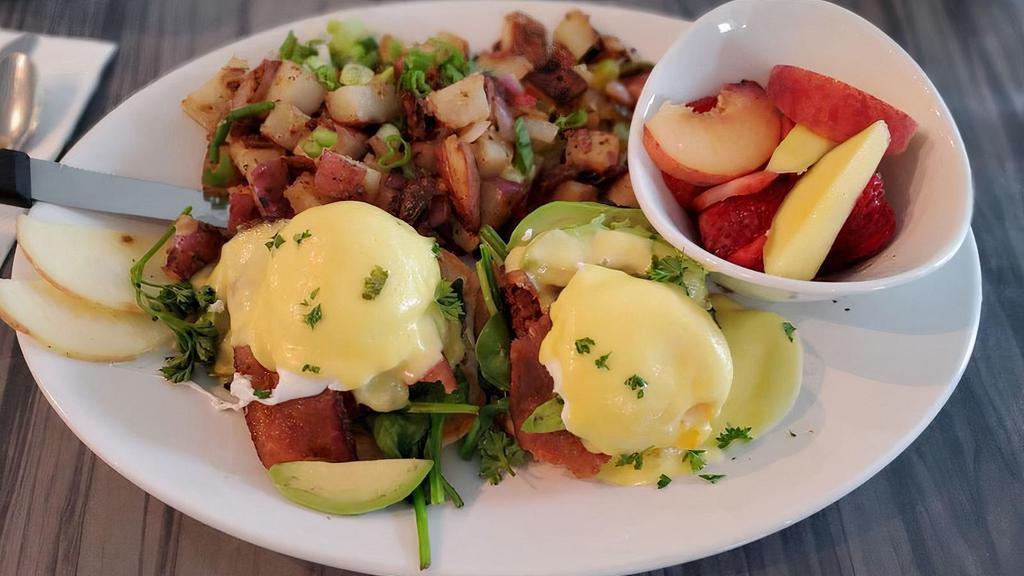 Eggs Benedict · Crispy english muffin with grilled thick cut smoked ham, poached eggs, and hollandaise sauce. served with potatoes and fruit.