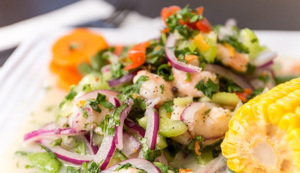 Ceviche De Camarón · Our Peruvian style shrimp ceviche.  Shrimp mixed with thinly sliced onion, celery and cilantro.  Served with a side of sweet potato and corn.