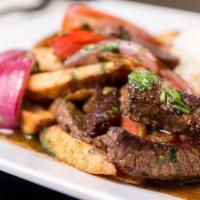 Lomo Saltado · Rib eye steak sautéed with onions, tomato, and hand pressed French fries. Served with a side...