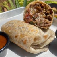 El Burrito · Your choice of Guiso or meat, white rice, whole beans, sour cream, and cheese wrapped 
in a ...