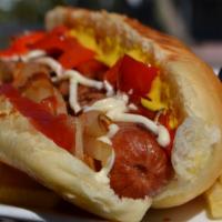 The Tj · A gourmet 1/4 lb. hot dog wrapped in bacon in a homemade bun, topped with ketchup, mayonnais...