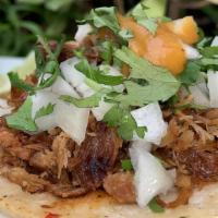 Carnitas Taco · Braised shredded pork; marinated in various spices, topped with onions, cilantro, and a mild...