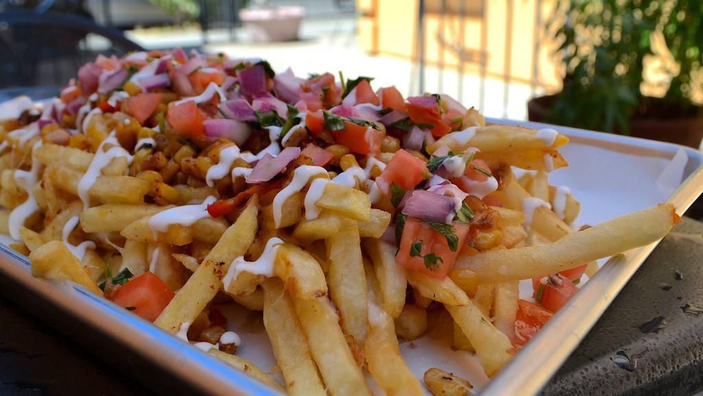 Esquite Fries · Special. french fries served with melted mozzarella cheese, pico de gallo, sour cream, grilled corn and red bell peppers, spices, and tajin.