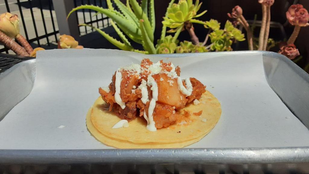 Papas Con Chorizo Taco · Potatoes, soybean chorizo, and various spices. Topped with sour cream and dried cotija cheese.