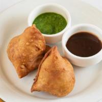 Vegetable Samosa · Crispy turnovers stuffed with mildly spiced potatoes and green peas.