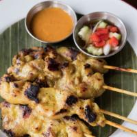 Satay Chicken · Marinated chicken breast with satay seasoning. Served with peanut sauce and pickled cucumber...
