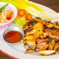Gai Yang · BBQ chicken. Served with sticky rice and a side of papaya salad.