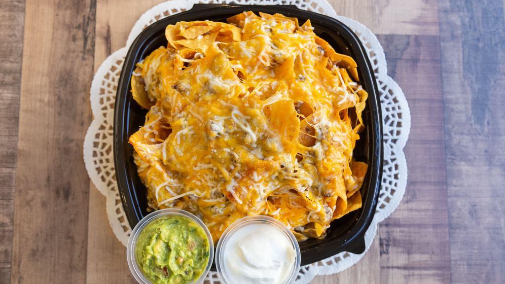 Pork Nachos · Homemade chips with cheese, your choice of meat, sour cream & guacamole.