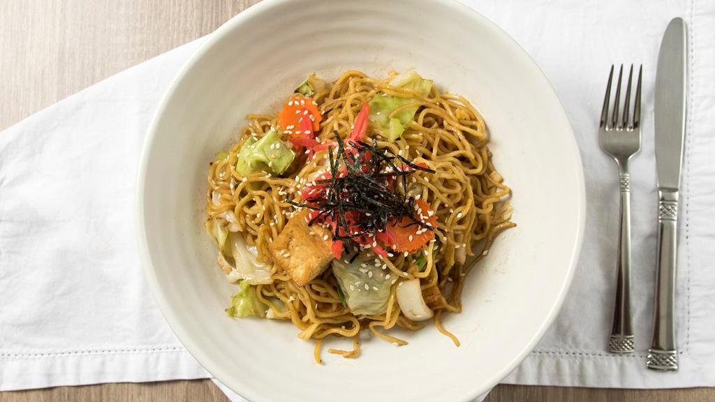 Yakisoba · Japanese home style stir-fried soba noodles with carrots, cabbage, white onions, green onions, mushroom, dried seaweed strips, pickled ginger, toasted sesame seeds.