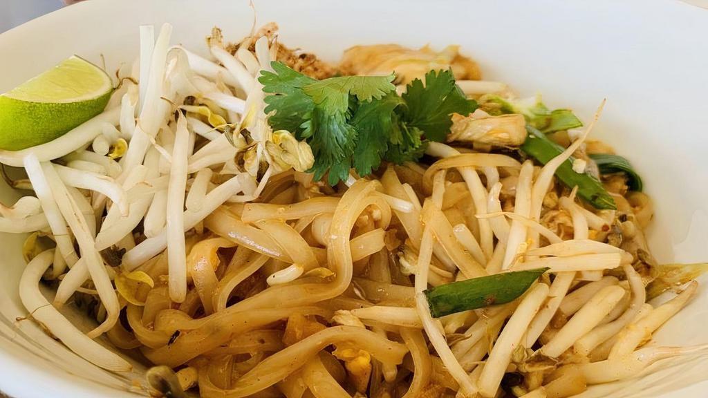 Pad Thai · Vegetarian. Gluten-free. Thin rice noodles, seasoned tamarind sauce, egg, bean sprouts, green onions, chopped shallots, salted turnip, crushed peanuts, and lime wedge.
