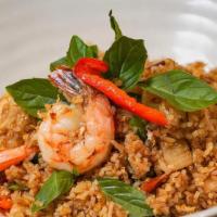 Spicy Basil Fried Rice · Jasmine rice, garlic, Thai chili, egg, white onions, carrots, bell pepper, basil  leaves.
