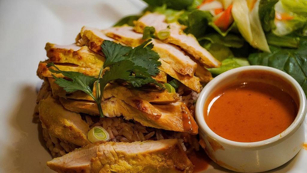 Grilled Chicken Over  Rice · Grilled Turmeric Coconut marinated Chicken Breast, Steamed Jasmine Rice, Green Mixed Salad with Sweet Vinegar Dressing, Peanut Dipping Sauce.