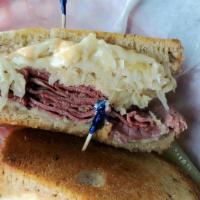 Uncle Reuben'S Reuben · Corned beef topped with sauerkraut. Swiss cheese and thousand island dressing grilled on rye...