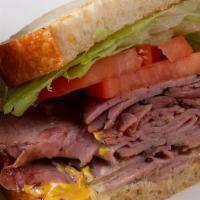 Roast Beef Sandwich · Served with lettuce, tomato, and a pickle spear.