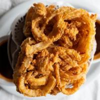 World Famous Onion Rings · Battered, fried onion loaf, house barbecue sauce, and BBQ ranch.