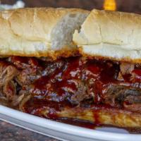 Bbq Tri Tip Sandwich · Thinly sliced tri-tip beef simmered in house barbecue sauce piled high on a French roll. Ser...