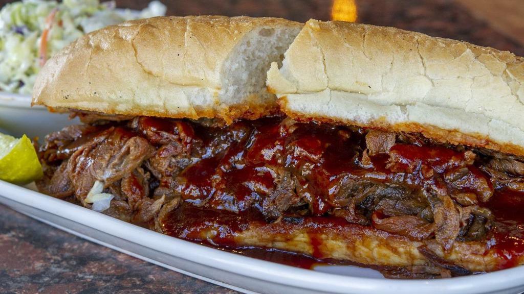 Bbq Tri Tip Sandwich · Thinly sliced tri-tip beef simmered in house barbecue sauce piled high on a French roll. Served with a pickle.
