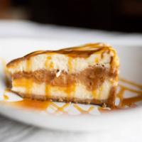 Dulce De Leche Cheesecake · A large slice of new York style cheesecake with your choice of strawberries, hot fudge, or c...