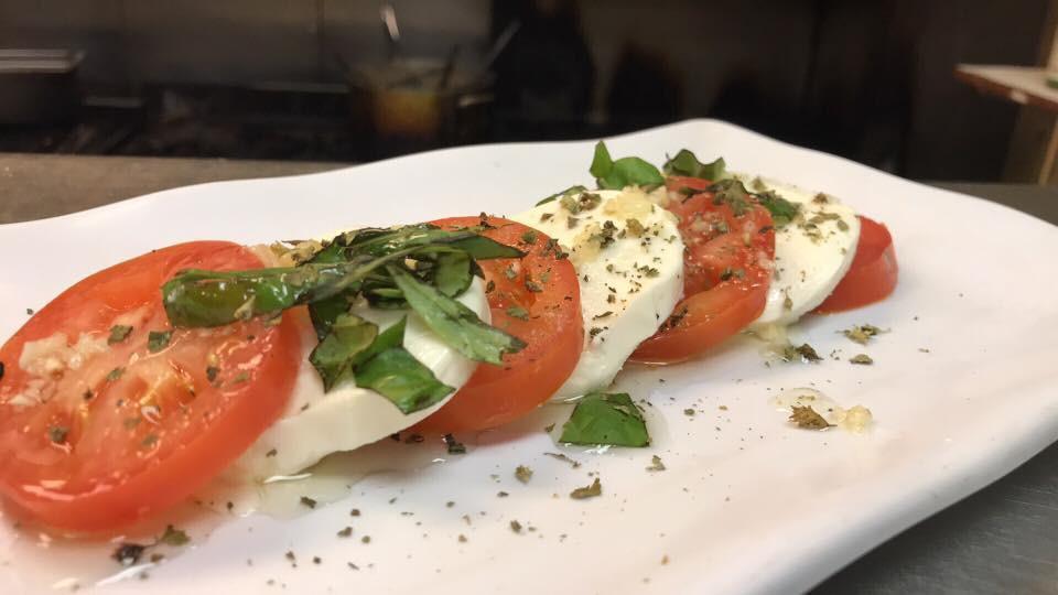 Caprese · Fresh mozzarella and fresh tomatoes, drizzled with extra virgin olive oil.