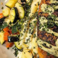 Salmon Steak · Pan seared, oven roasted salmon steak, topped with a pesto remoulade sauce. Served with geme...