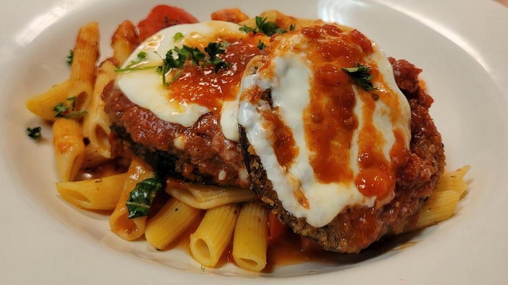Eggplant Parmigiana · Panko breaded eggplant, layered with Marinara Sauce, Mozarella, and Parmigiano cheese. Served with a Penne pasta and vegetables.