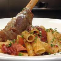 Lamb Shank · Cooked in a Maraqua sauce (tomatoes, carrots, celery, and onions) for several hours and serv...