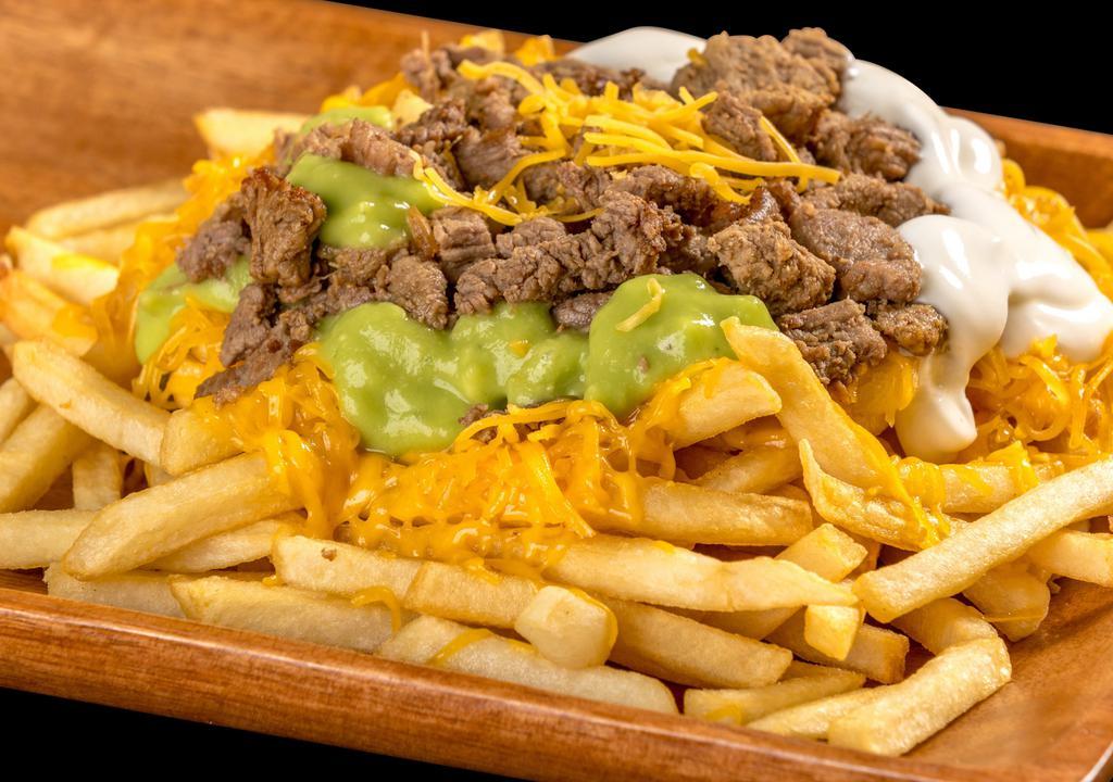 Carne Asada Fries · French fries, guacamole, sour cream, cheese, and carne asada (steak)