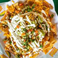 Super Nachos · Corn tortilla chips topped with beans cheese guacamole sour cream pico de gallo and carne as...