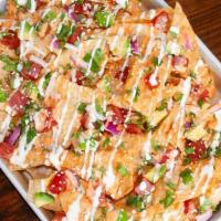 Poke Nachos · wonton chips | Sushi grade ahi tuna | poke sauce | avocado | green onion | red onion | cilan...