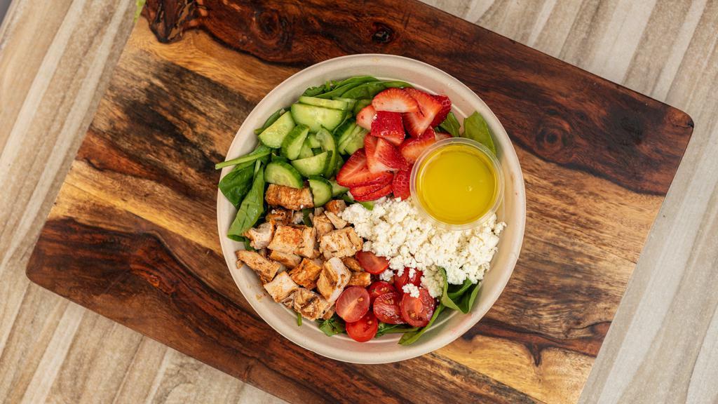 Strawberry Lemonade Salad · Baby spinach, homemade chopped chicken breast, crumbled feta, cherry tomato, cucumber, sliced strawberries & an olive oil lemon dressing.