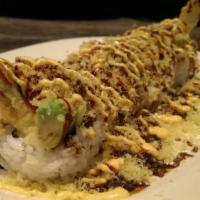 Crunchy Roll · Shrimp tempura, imitation crab, avocado, & cucumber roll topped w/ crunch, eel sauce, & spic...
