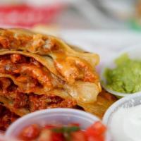 Al Pastor Quesadilla · ON FLOUR TORTILLA WITH ROTISSERIE MARINATED PORK AND SIDES OF GUACAMOLE, SOUR CREAM, AND PIC...